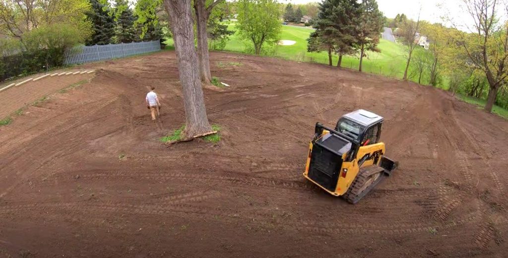 Skid steer grading for lawn installation in Des Moines